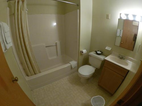 a bathroom with a toilet and a sink and a shower at Budget Inn Clearfield PA in Clearfield