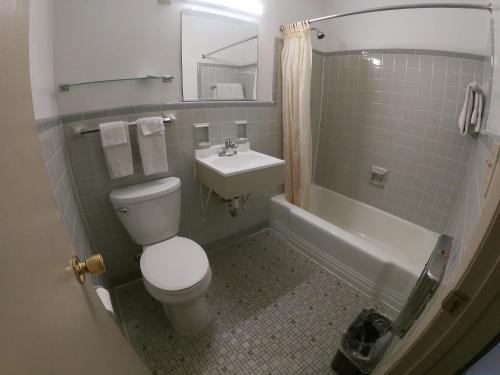 a bathroom with a toilet and a sink at Budget Inn Clearfield PA in Clearfield