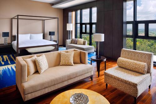 a living room with a couch and a bed at Kigali Marriott Hotel in Kigali