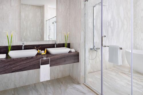 a bathroom with two sinks and a shower at Kigali Marriott Hotel in Kigali