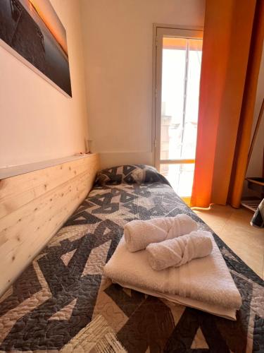 a bedroom with a bed with two towels on it at Birgi House Stagnone in Marsala