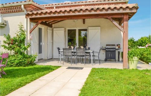 a patio with a table and chairs under a pergola at Cozy Home In Saint-Georges in Bourlens