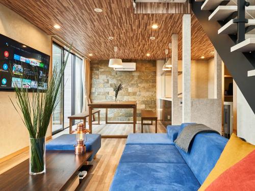 a living room with a blue couch and a table at Rakuten STAY VILLA Lake Yamanakako 103 Pets allowed with dog run in Yamanakako
