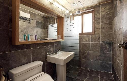 a bathroom with a toilet and a sink at Hanok Stay Namwonyechon by Kensington in Namwon