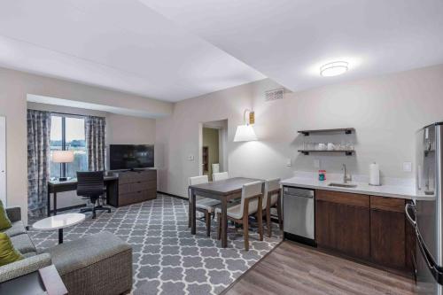 a living room with a kitchen and a dining room at Residence Inn by Marriott Atlanta Covington in Covington