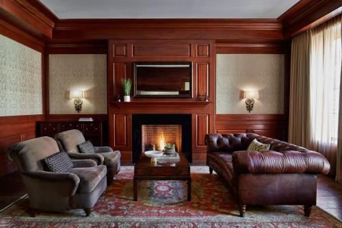 a living room with two couches and a fireplace at Lancaster Marriott at Penn Square in Lancaster