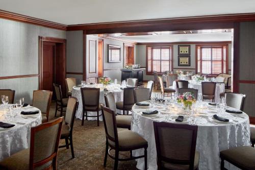a banquet room with tables and chairs with white tablecloths at Lancaster Marriott at Penn Square in Lancaster