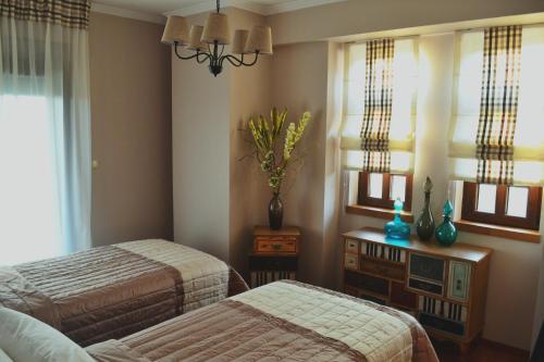 a bedroom with two beds and a window at Evmorfes Villas in Poligiros