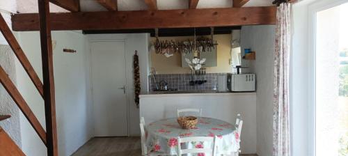 a kitchen with a table with a table cloth on it at La Mez a Nine gîtes in Buxières-sous-Montaigut