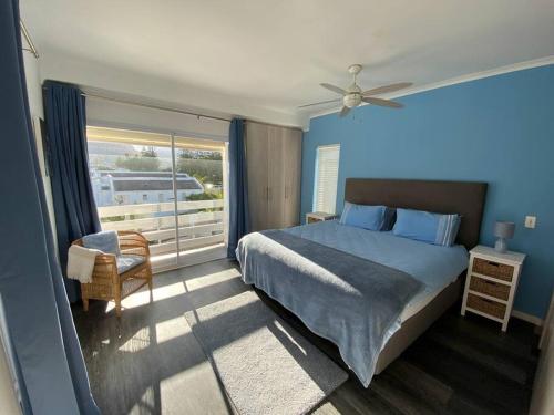 a bedroom with a bed and a window with a balcony at Audiophile Relax Hideaway on the Water in Cape Town