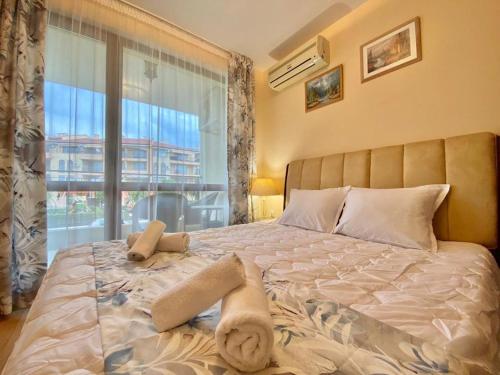 a bedroom with a large bed with a large window at Apartment Monica in Sveti Vlas