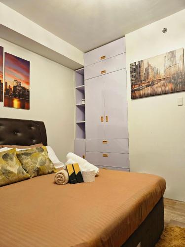 a bedroom with a bed and a closet at JETS'3 Condo Rentals in Bacolod