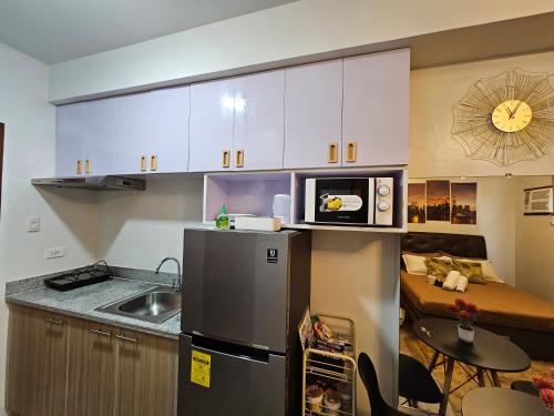 a small kitchen with a sink and a refrigerator at JETS'3 Condo Rentals in Bacolod