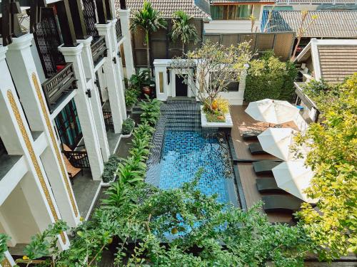 an overhead view of a swimming pool in a garden at Thai Akara - Lanna Boutique Hotel in Chiang Mai