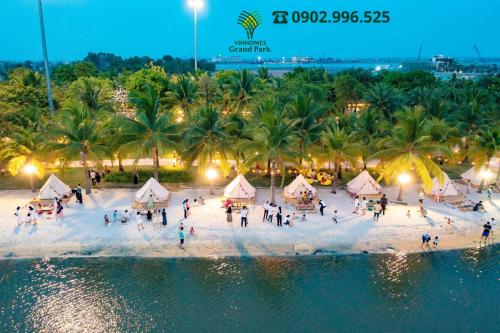 a group of people on a beach near the water at Homestay Sài Gòn-Vinhomes Grand Park Quận 9-Plus 2PN in Long Bình