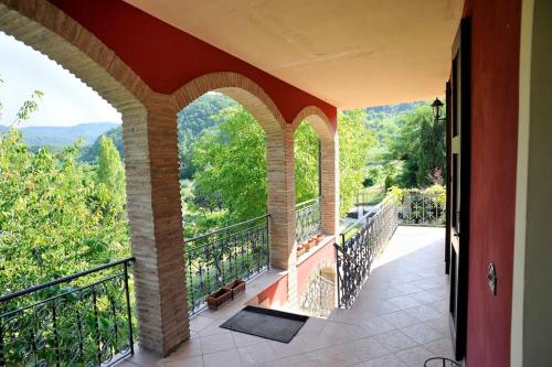 an indoor balcony with a view of the mountains at Villa per gruppi fino a 20 persone, con piscina privata, camino e grande giardino nelle colline marchigiane in Pian di Mulino
