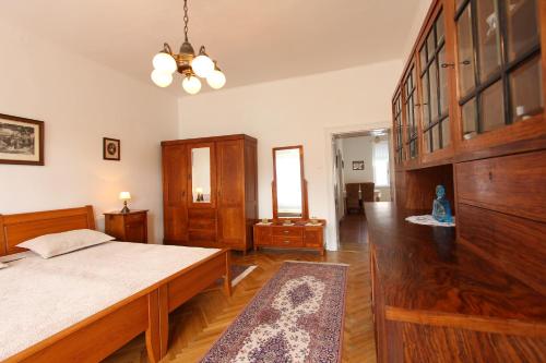 a bedroom with a bed and wooden furniture at Penzion Jelen Vranov nad Dyjí in Vranov nad Dyjí