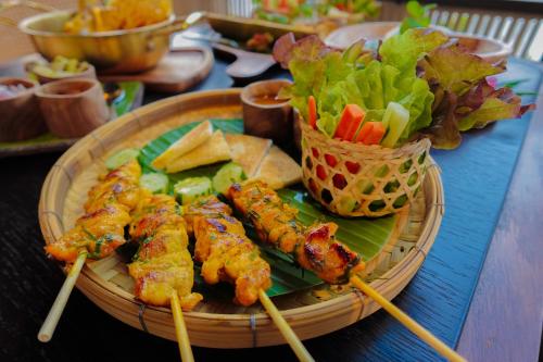a plate of food with meat and vegetables on a table at Patamma Hideaway Resort in Nan