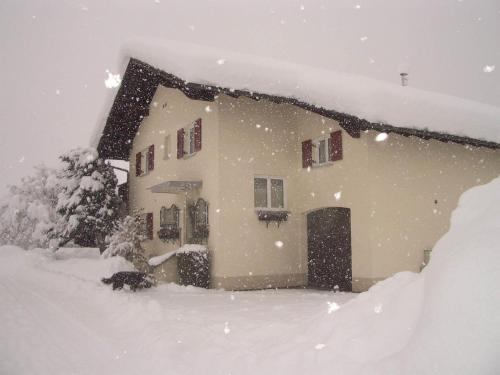a house covered in snow in a yard at Panoramablick in Schruns-Tschagguns