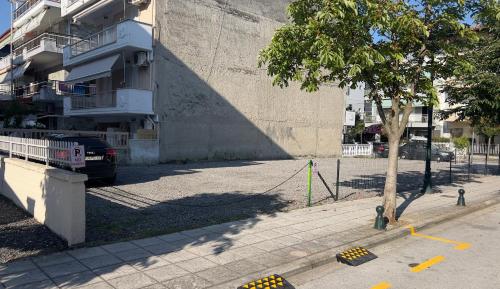 a street with a tree and a building at Hotel Hermes Pieria in Olympic Beach