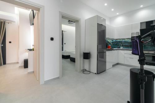 a kitchen with white cabinets and a sink at SithoniaRS Luxury 2nd Floor Roofgarden Apartment With Unique Seaview in Neos Marmaras