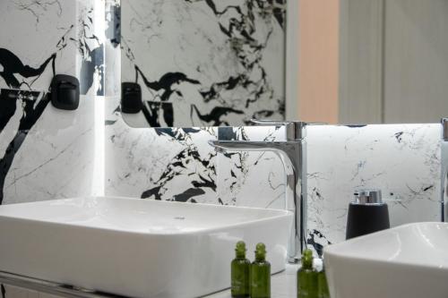a bathroom with a white sink and a mirror at SithoniaRS Luxury 2nd Floor Roofgarden Apartment With Unique Seaview in Neos Marmaras