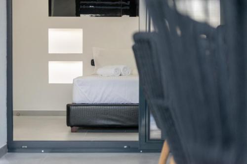 a bedroom with a bed and a mirror at SithoniaRS Luxury 2nd Floor Roofgarden Apartment With Unique Seaview in Neos Marmaras