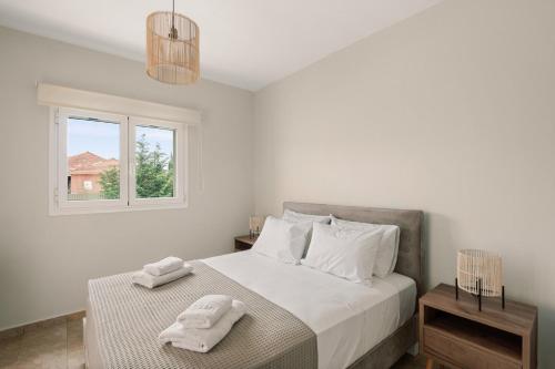 a bedroom with a bed with two towels on it at Vasilopoulos Residences - Villa Chloe with private pool in Argostoli