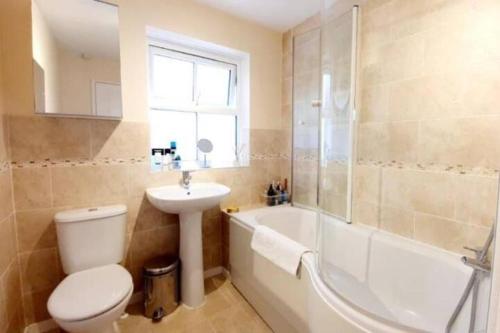 a bathroom with a toilet and a sink and a bath tub at 1 small double room in a cul de sac classy area in a shared house in Bristol