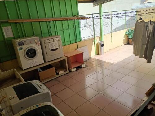 a laundry room with a washer and a washing machine at Tong Bing Express in Hsinchu City