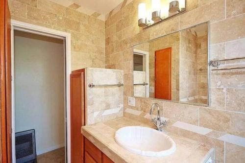 a bathroom with a sink and a large mirror at 3 BR + Near Venice Beach + Redecorated + Nice Backyard with BBQ in Los Angeles