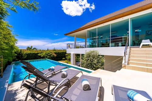 a villa with a swimming pool and a house at Phu Montra Villa with Ocean View in Khao Tao