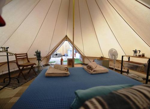 a tent with two beds in front of it at Happy Glamping 2 in Kalamaki Heraklion