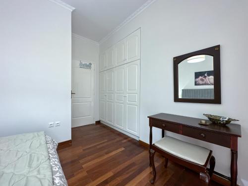 a bedroom with a desk and a mirror on the wall at TheasHomly in Kastanéa