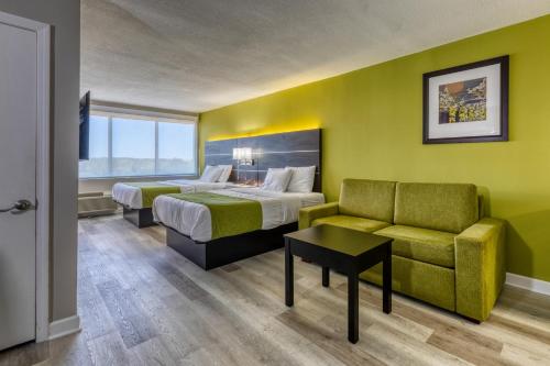 a hotel room with two beds and a couch at Hotel Weston in Marietta