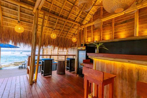 a restaurant with a bar with a view of the ocean at Beach & Bliss Mirissa in Mirissa
