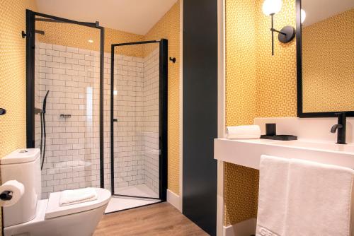 a bathroom with a shower and a toilet and a sink at Genteel Home Betis 67 in Seville