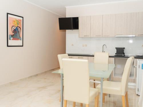 a kitchen and dining room with a table and chairs at ALLAGIANNIS GROUP APARTMENTS in Markopoulo