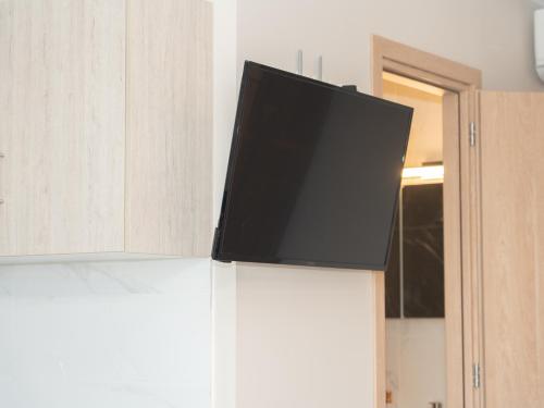 a flat screen tv sitting on top of a cabinet at ALLAGIANNIS GROUP APARTMENTS in Markopoulo