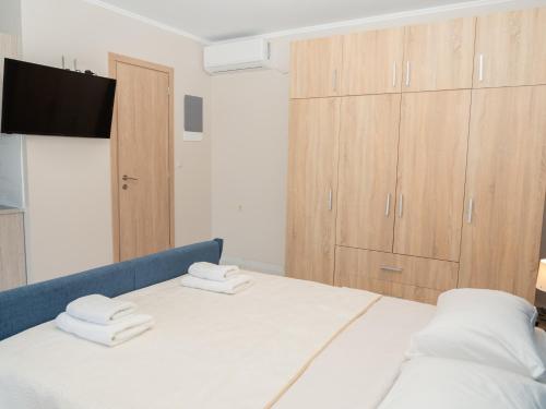 a bedroom with a bed with two towels on it at ALLAGIANNIS GROUP APARTMENTS in Markopoulo