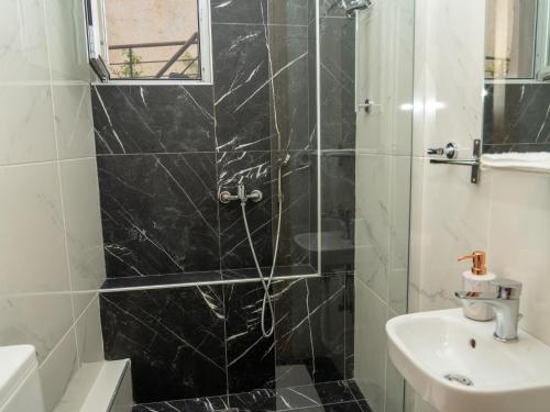 a bathroom with a shower and a sink at ALLAGIANNIS GROUP APARTMENTS in Markopoulo