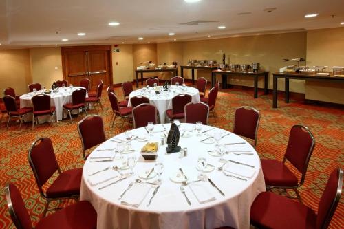 a conference room with tables and chairs and a buffet at Marriott Venezuela Hotel Playa Grande in Playa Grande