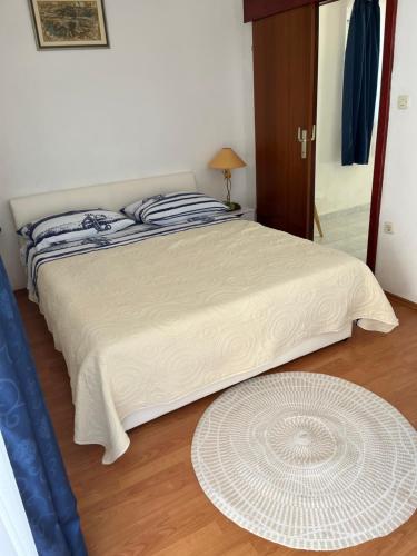 a bedroom with a large bed with a white comforter at Apartments Despotović in Vis