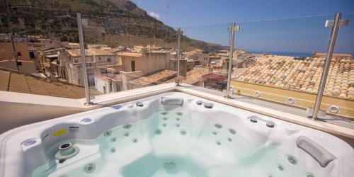 a hot tub with a view of a city at Sciabika Home - Edificio Eolie in Castellammare del Golfo