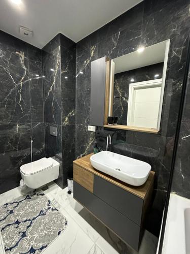 a bathroom with a sink and a mirror at Polo villas Batumi in Batumi
