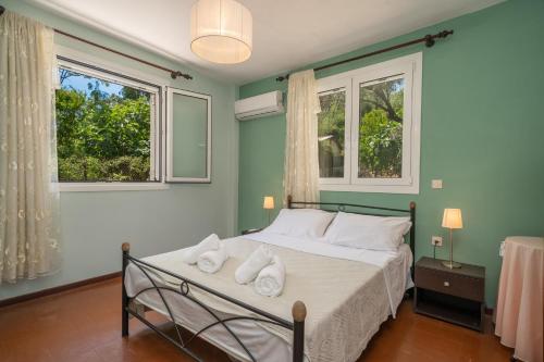 ein Schlafzimmer mit einem Bett mit Handtüchern darauf in der Unterkunft Artemis House in Karavomylos