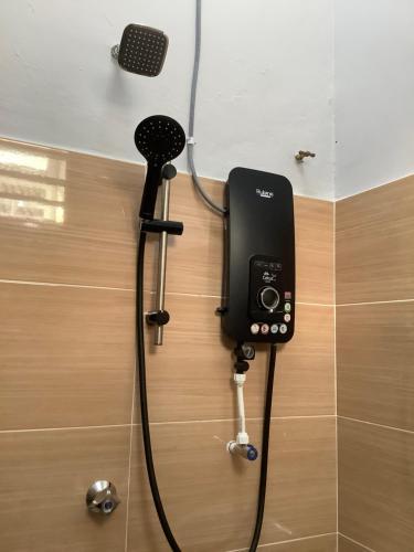 a phone is attached to a wall in a bathroom at Homestay Umi in Kijal