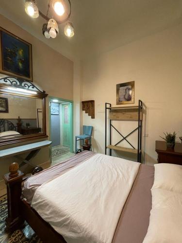 a bedroom with a large bed and a mirror at Alf leila wa leila boutique in Haifa