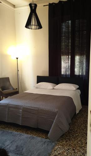 a bedroom with a large bed and a lamp at Angolo Relax Camere king in Rimini