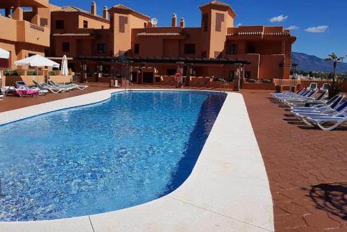 een zwembad voor een resort bij Elegant 2BR Apartment Puerto Banus Marbella just 12 Minutes Away by G00gIeMaps in Estepona